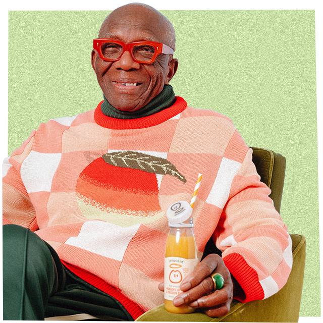 man wearing big  knitwear jumper and drinking an innocent smoothie